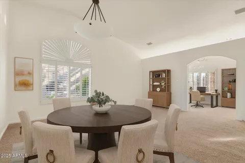 a view of a dining room with furniture and window