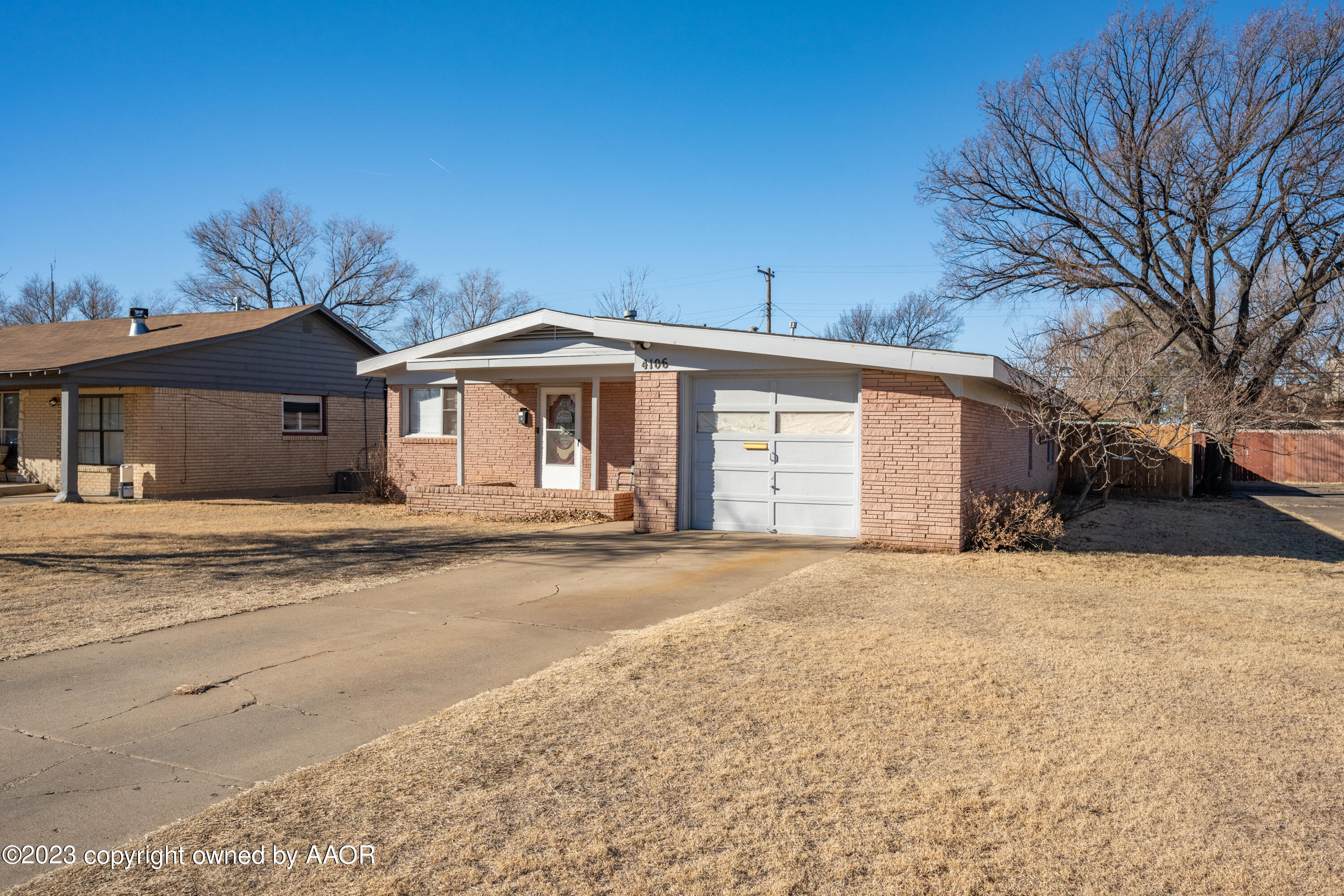 4106 Crockett Street Amarillo, TX 79110 - Photo 3 of 24 a front view of a house with a yard and garage
