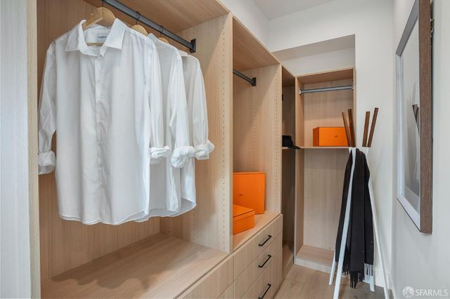 a bedroom with a bed and large windows