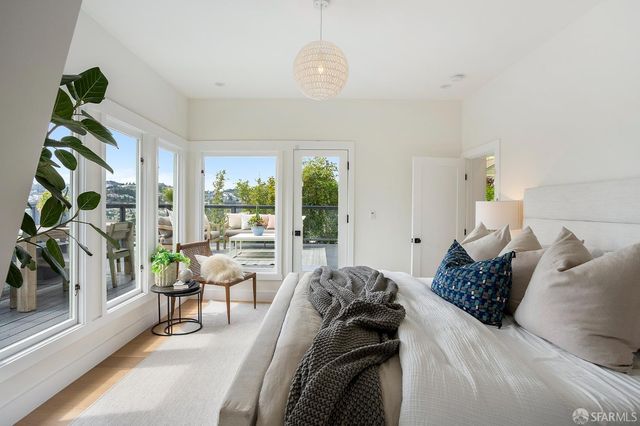 a balcony with wooden floor and furniture
