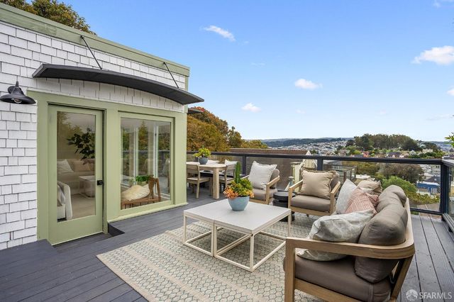 a view of a patio with table and chairs and potted plants