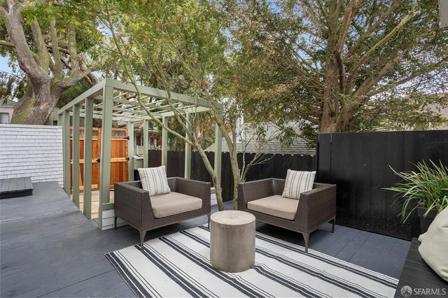 a front view of a house with a tree