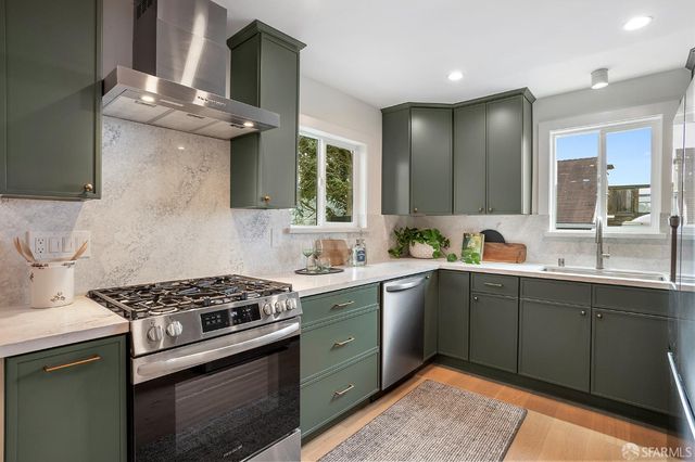 a kitchen with a sink cabinets and stainless steel appliances