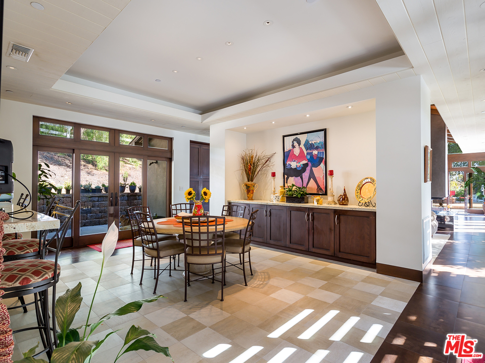 24754 Robert Guy Road Hidden Hills, CA 91302 - Photo 12 of 18 a living room with furniture a piano and a painting on the wall