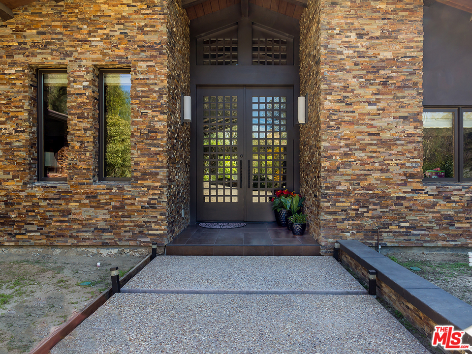 24754 Robert Guy Road Hidden Hills, CA 91302 - Photo 15 of 18 a view of a brick house with an empty space