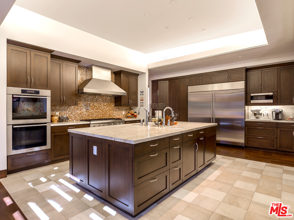 24754 Robert Guy Road Hidden Hills, CA 91302 - Photo 4 of 18 a kitchen with stainless steel appliances granite countertop a stove a sink and a microwave