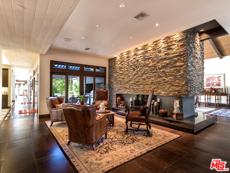 24754 Robert Guy Road Hidden Hills, CA 91302 - Photo 8 of 18 a living room with furniture and a fireplace