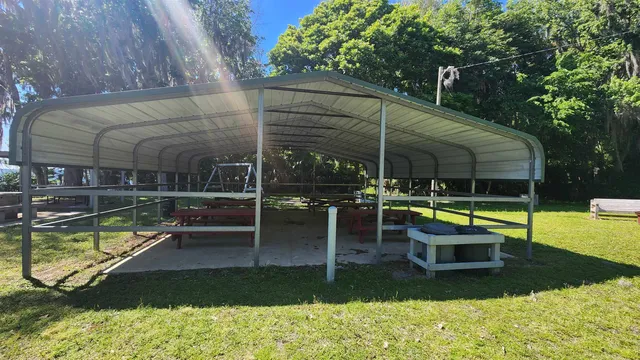 a view of a house with backyard and sitting area