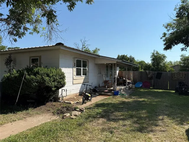 a view of a chair and table in backyard