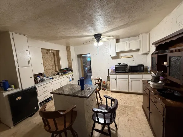 a kitchen with a sink stove and white cabinets