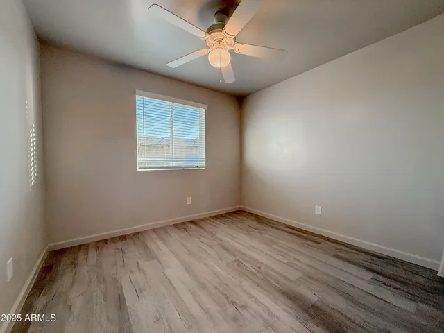 an empty room with wooden floor and door