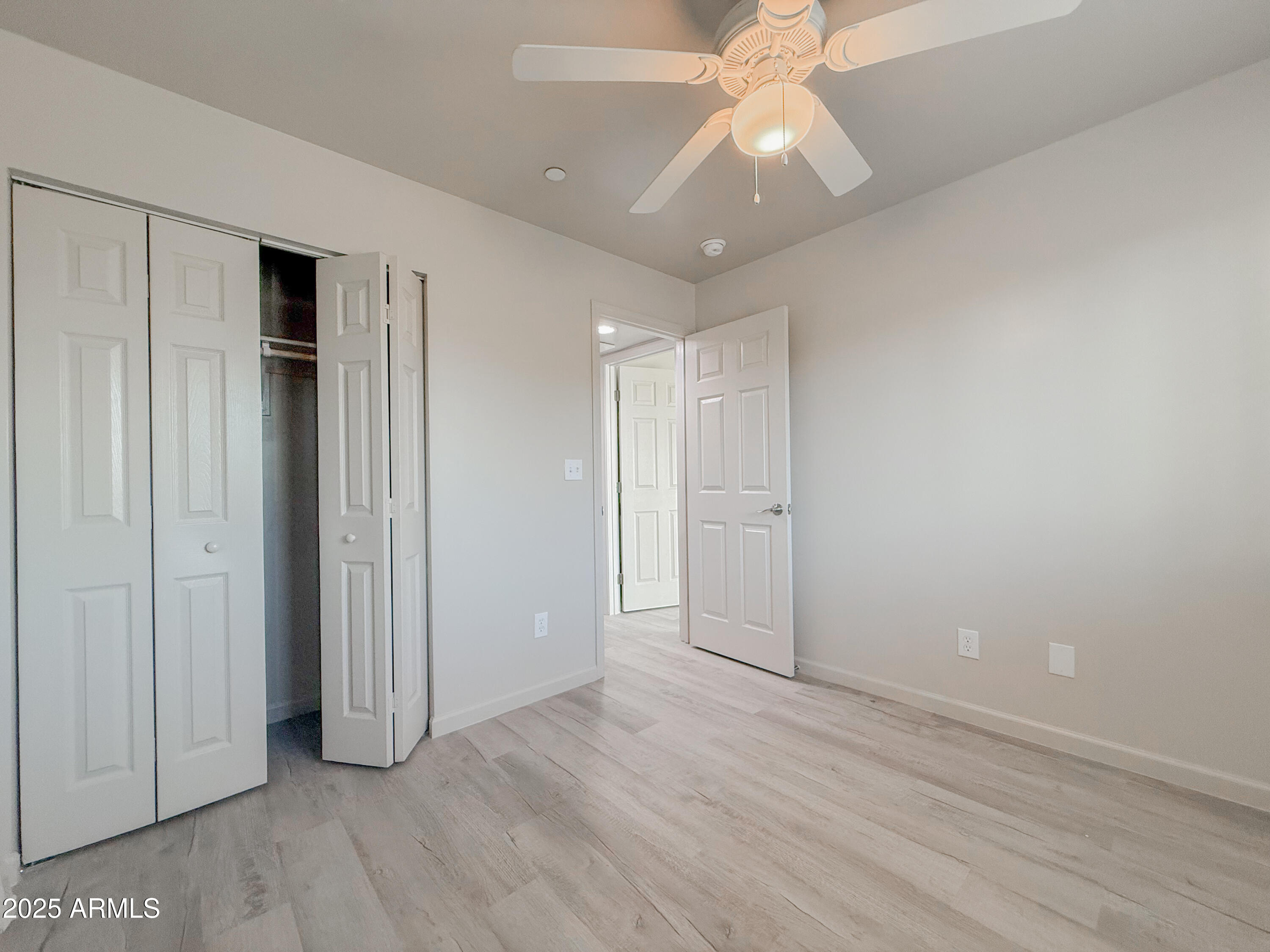 2121 West Adams Street, Unit A103 Phoenix, AZ 85009 - Photo 15 of 22 an empty room with wooden floor and door