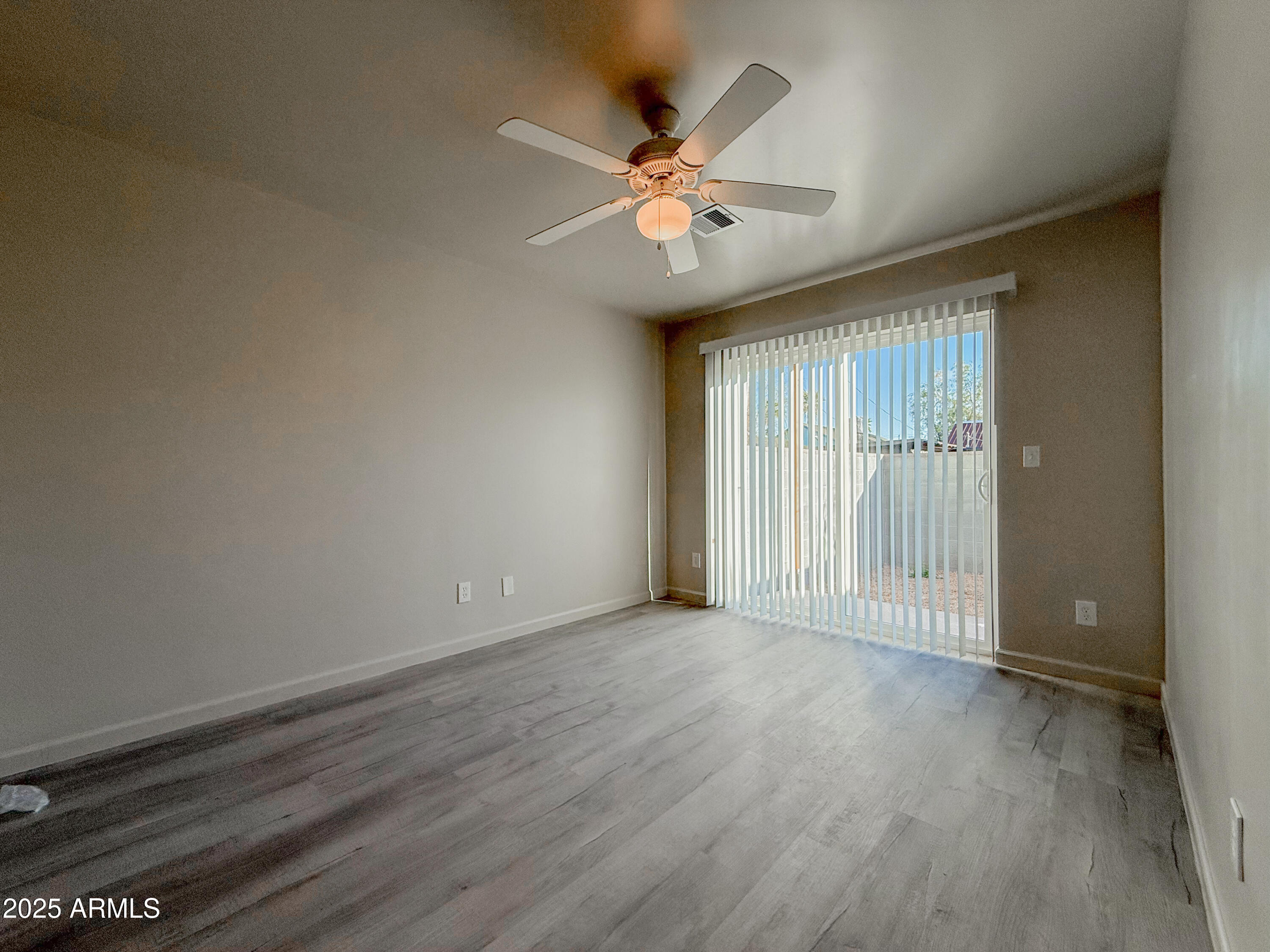 2121 West Adams Street, Unit A103 Phoenix, AZ 85009 - Photo 17 of 22 an empty room with wooden floor fan and windows