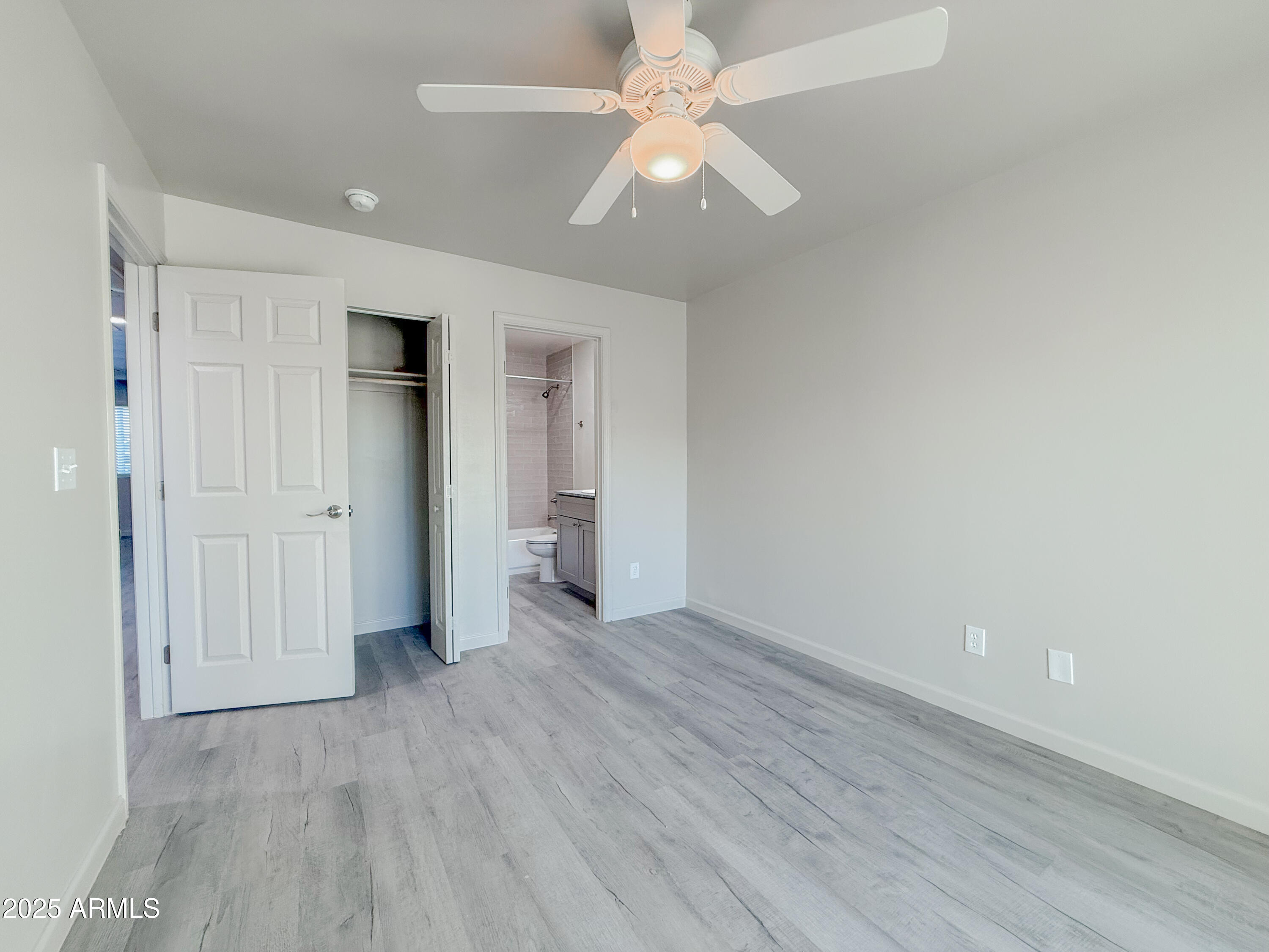 2121 West Adams Street, Unit A103 Phoenix, AZ 85009 - Photo 18 of 22 wooden floor in an empty room with a window