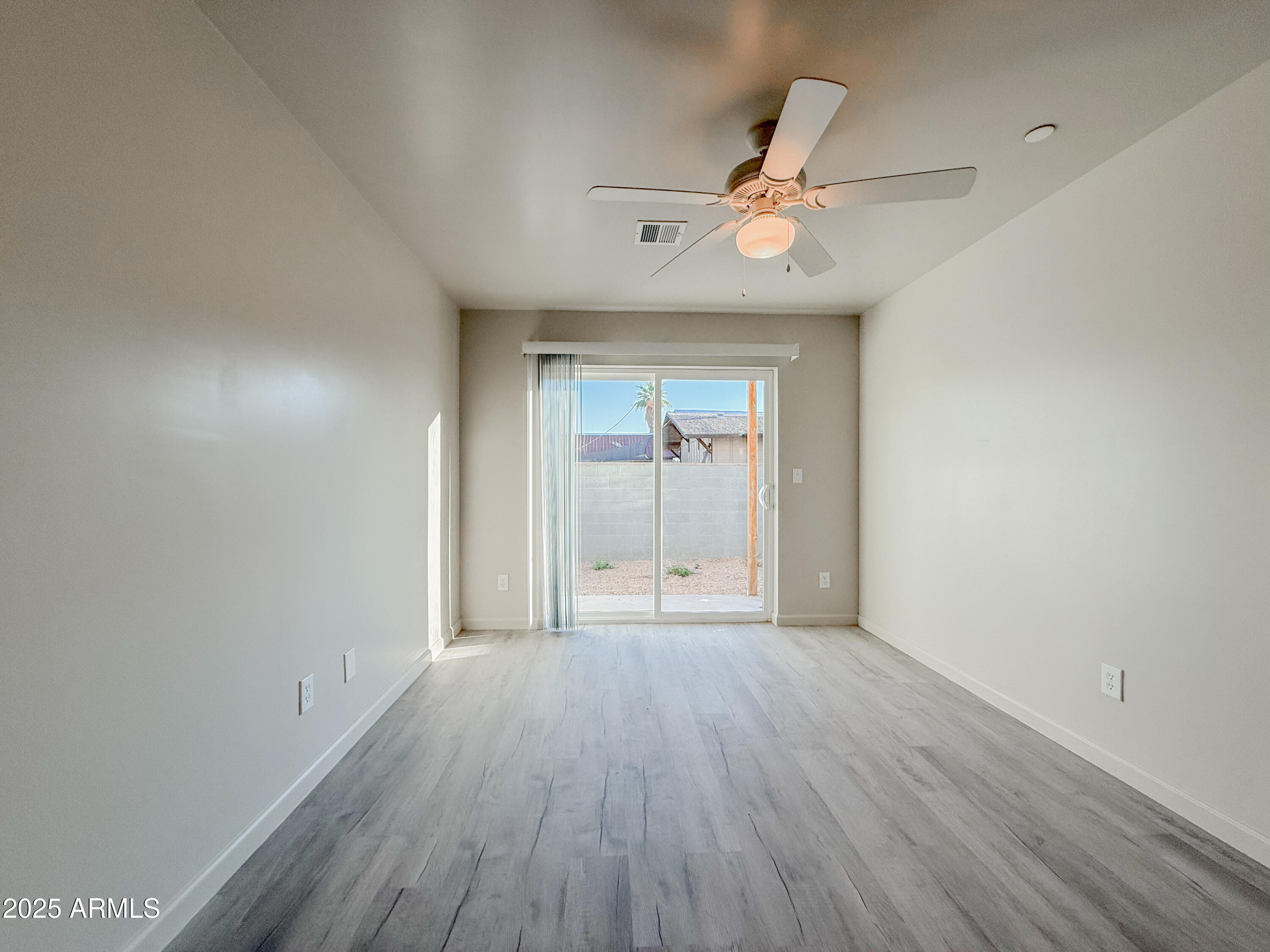 2121 West Adams Street, Unit A103 Phoenix, AZ 85009 - Photo 19 of 22 wooden floor in an empty room with a window