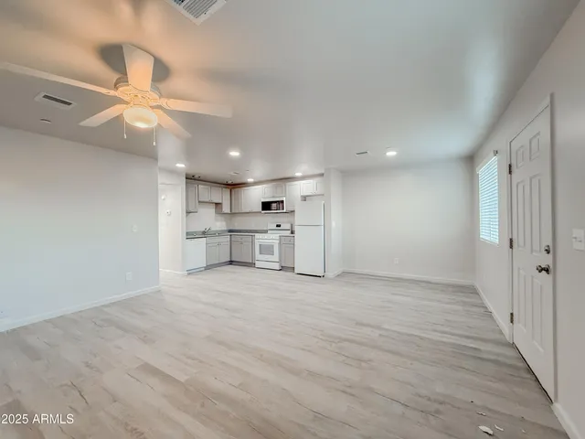 a view of a kitchen with a sink and a stove top oven