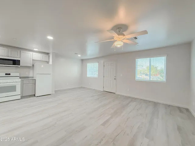 a kitchen with stainless steel appliances a refrigerator sink and cabinets