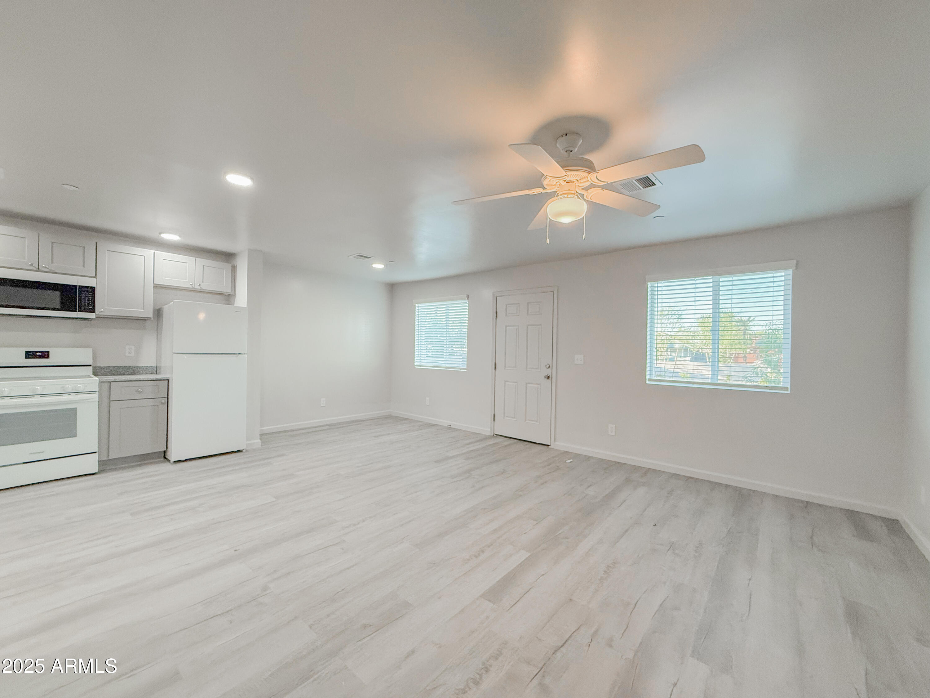 2121 West Adams Street, Unit A103 Phoenix, AZ 85009 - Photo 8 of 22 a view of a kitchen with a sink and a stove top oven