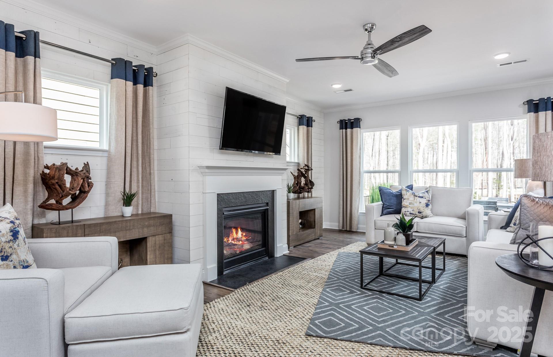 4741 Formation Court, Unit 43 Lancaster, SC 29720 - Photo 4 of 9 a living room with furniture a fireplace and a flat screen tv