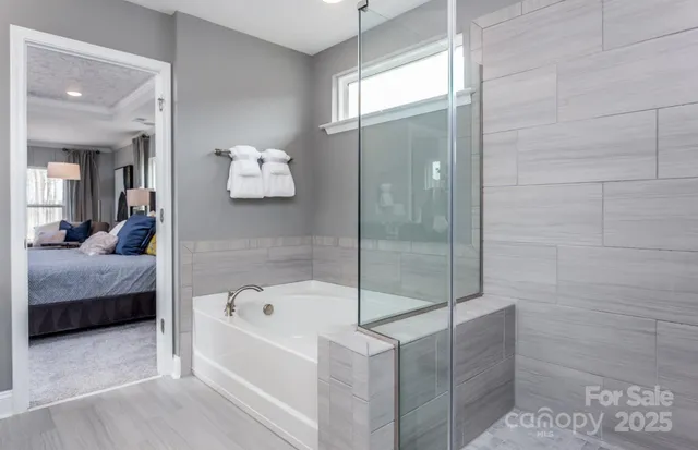 a bathroom with a tub and a shower
