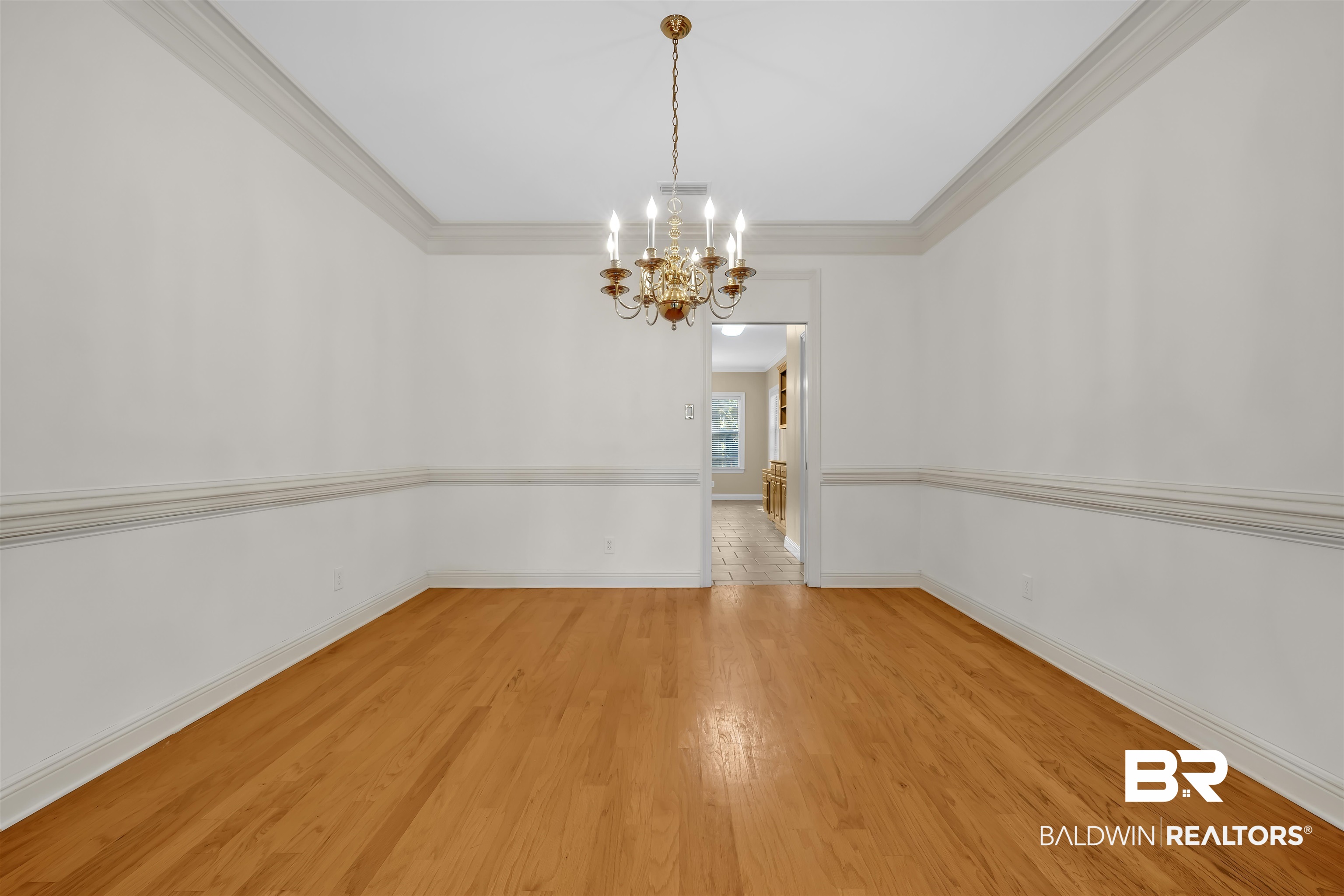 1262 Patrick Street Daphne, AL 36526 - Photo 7 of 35 Spare room with a chandelier, light wood-style flooring, and ornamental molding