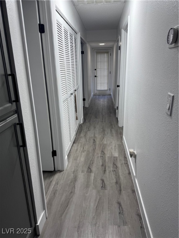 2044 Waverly Circle Henderson, NV 89014 - Photo 10 of 14 Hallway with light wood-style flooring, a textured