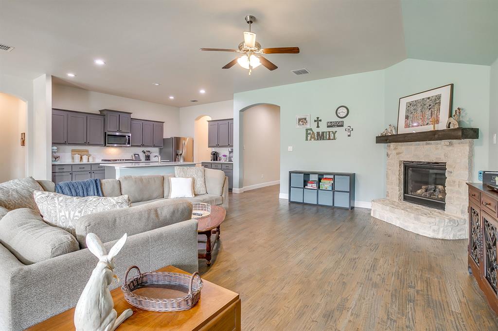 15141 Fleet Hill Road Aledo, TX 76008 - Photo 5 of 37 Living is anchored by a beautiful stone fireplace and ceiling fan.