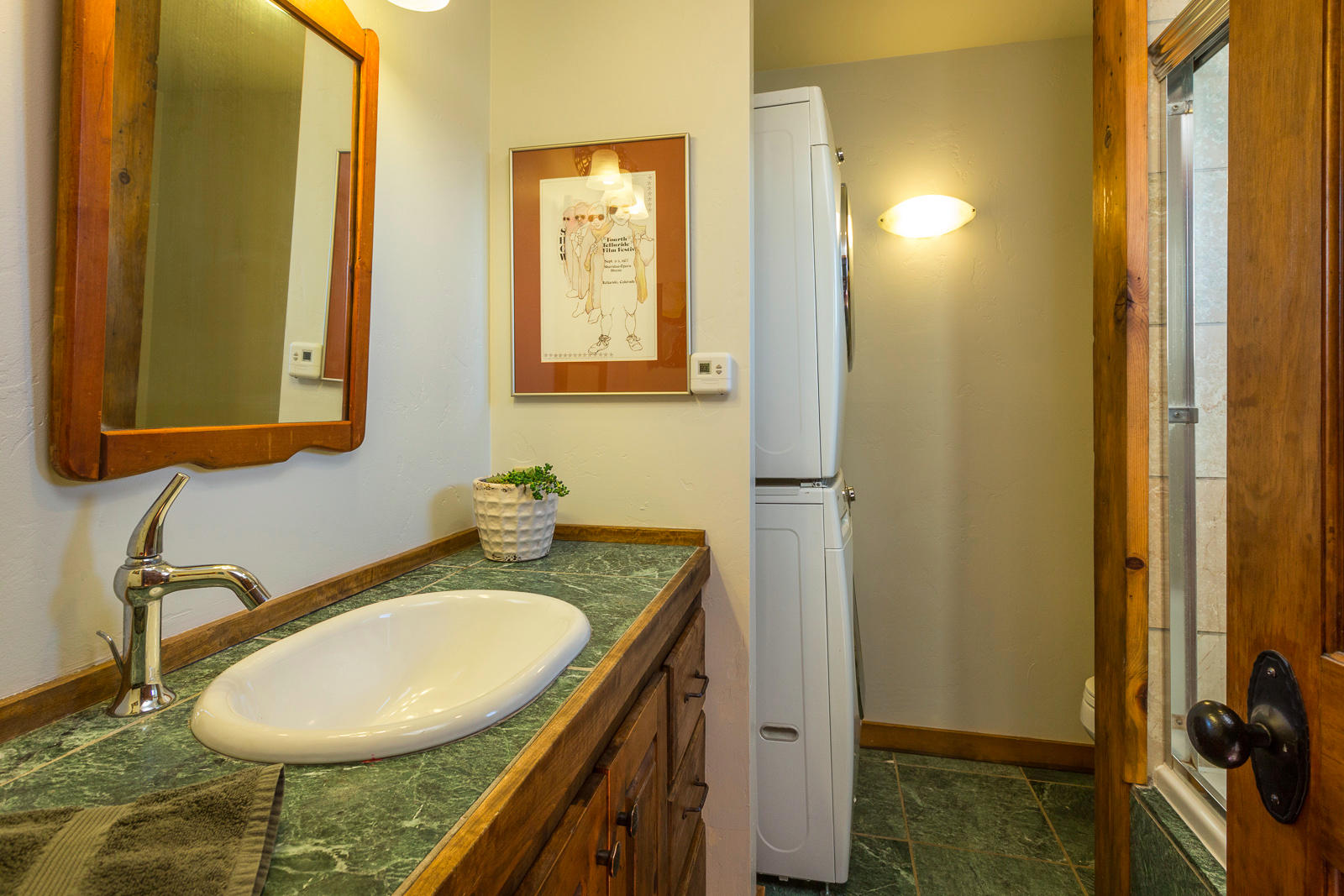 799 Harcourt Trail Placerville, CO 81430 - Photo 11 of 29 a bathroom with a granite countertop sink and a mirror