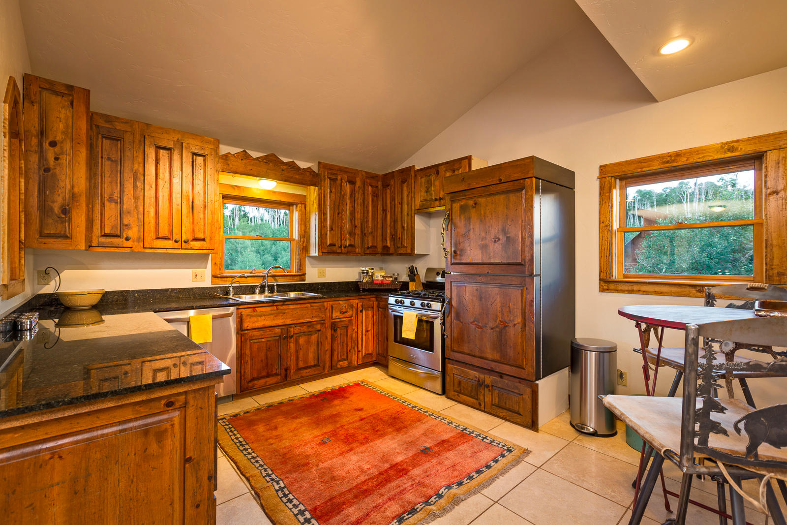 799 Harcourt Trail Placerville, CO 81430 - Photo 8 of 29 a kitchen with stainless steel appliances granite countertop a refrigerator stove top oven dining table and chairs