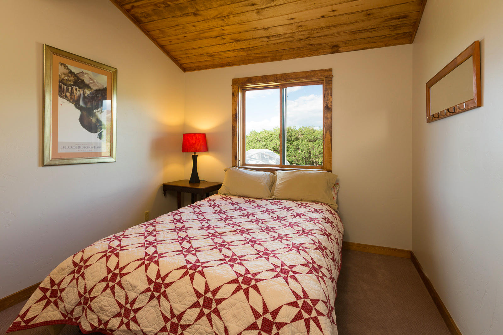 799 Harcourt Trail Placerville, CO 81430 - Photo 9 of 29 a bedroom with a bed and a painting on the wall