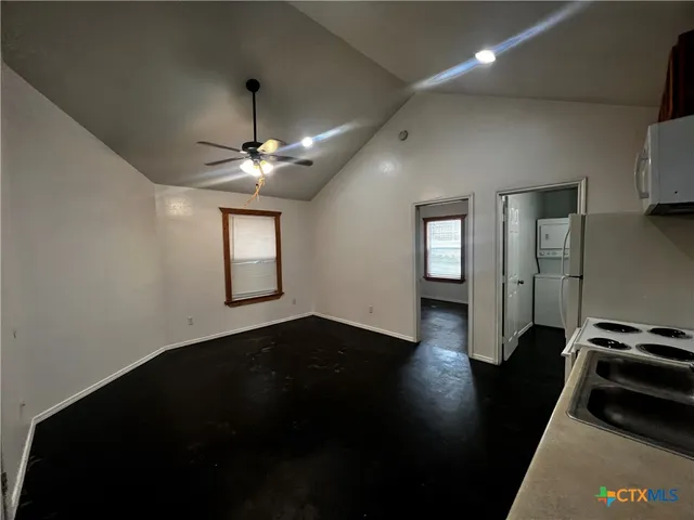 a view of a livingroom with wooden floor and a ceiling fan