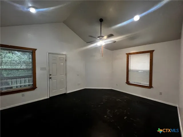 a view of an empty room with a window