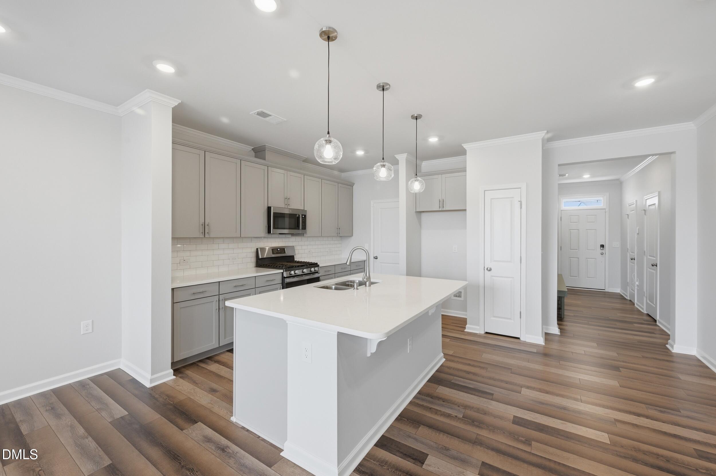 5011 Kota Street Raleigh, NC 27610 - Photo 11 of 42 a kitchen with a sink stainless steel appliances and cabinets