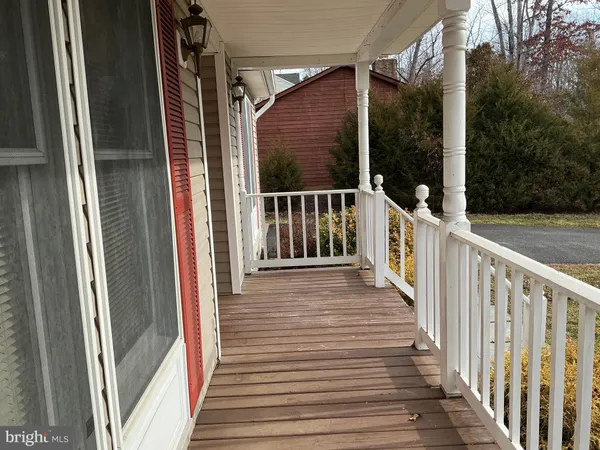 a view of a balcony with wooden floor and fence
