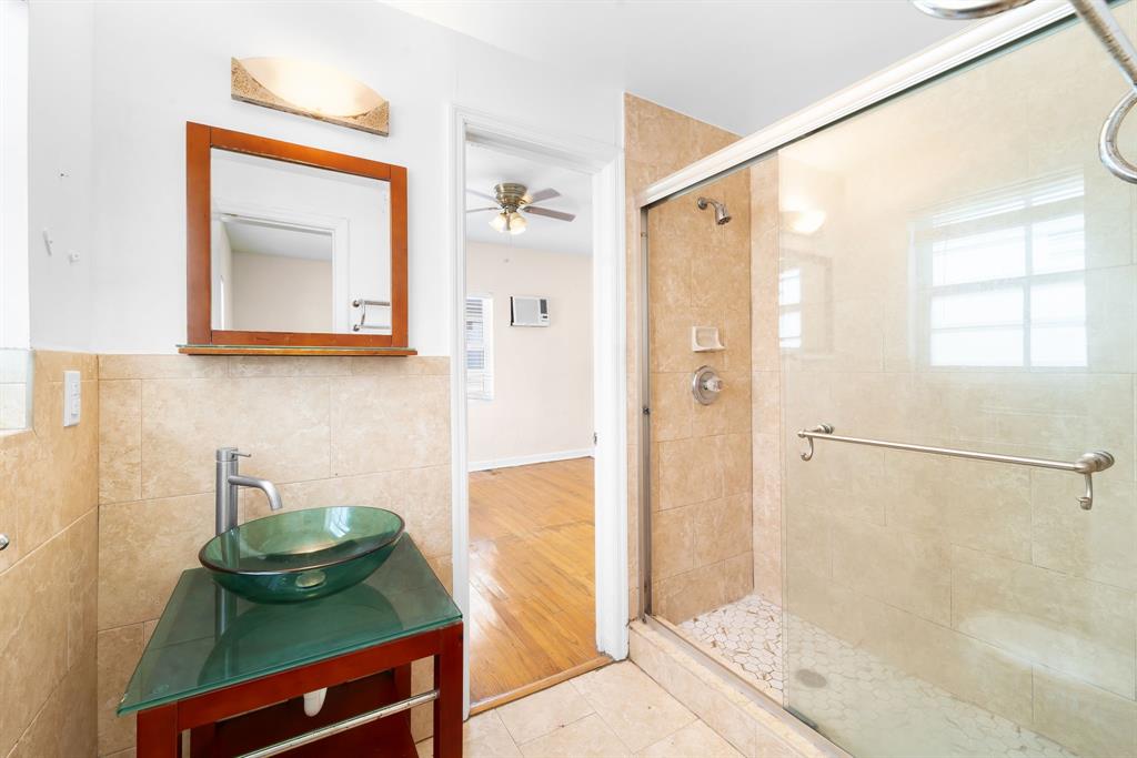 1241 13th Street, Unit 4 Miami Beach, FL 33139 - Photo 11 of 19 a bathroom with a sink a mirror and a shower