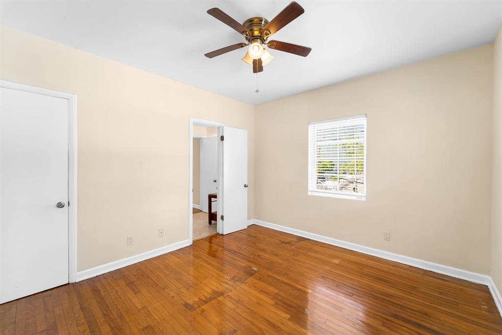 1241 13th Street, Unit 4 Miami Beach, FL 33139 - Photo 12 of 19 a view of a big room with wooden floor and a chandelier fan