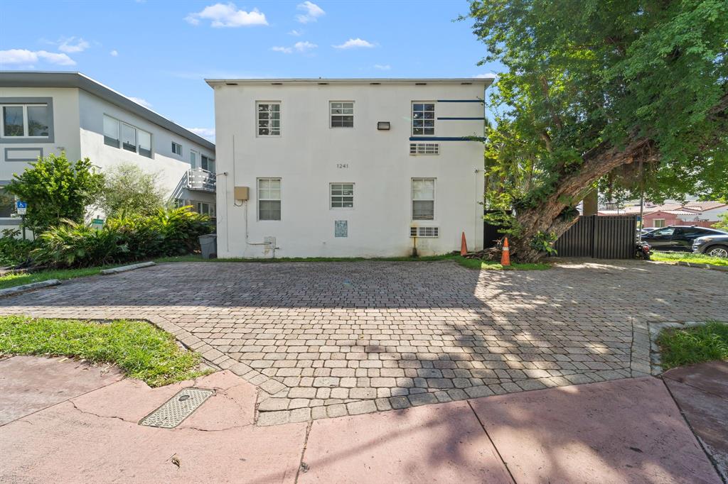1241 13th Street, Unit 4 Miami Beach, FL 33139 - Photo 19 of 19 a view of a grey house with a yard