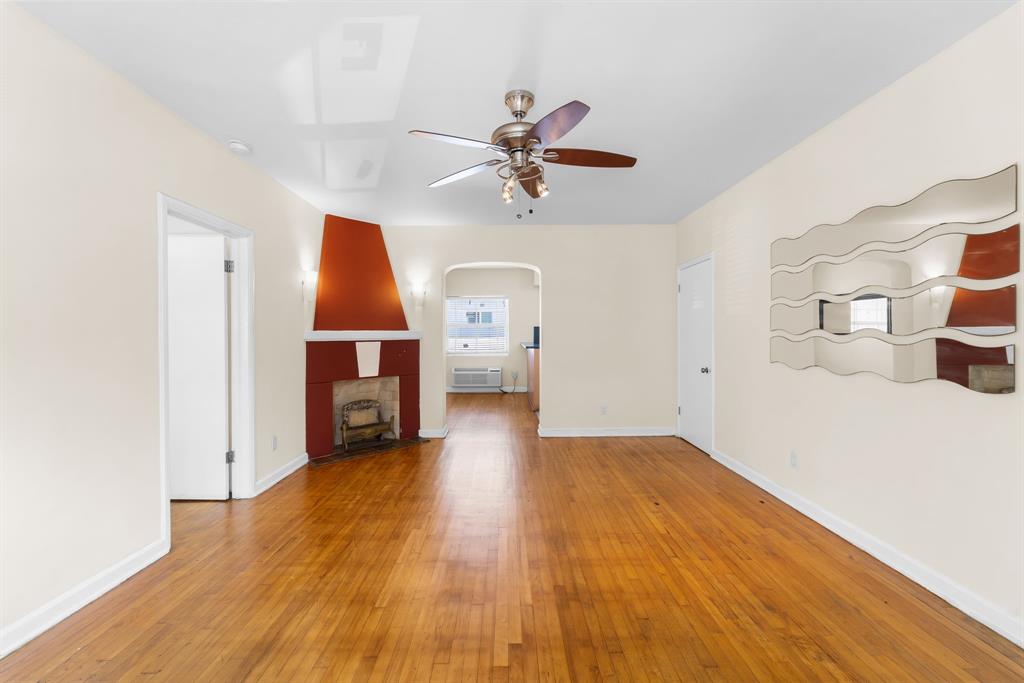 1241 13th Street, Unit 4 Miami Beach, FL 33139 - Photo 3 of 19 a view of a kitchen with wooden floor and a ceiling fan