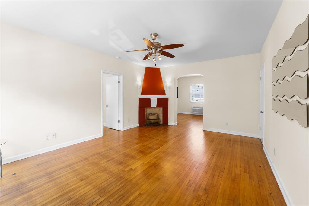1241 13th Street, Unit 4 Miami Beach, FL 33139 - Photo 4 of 19 a view of empty room with wooden floor and fan