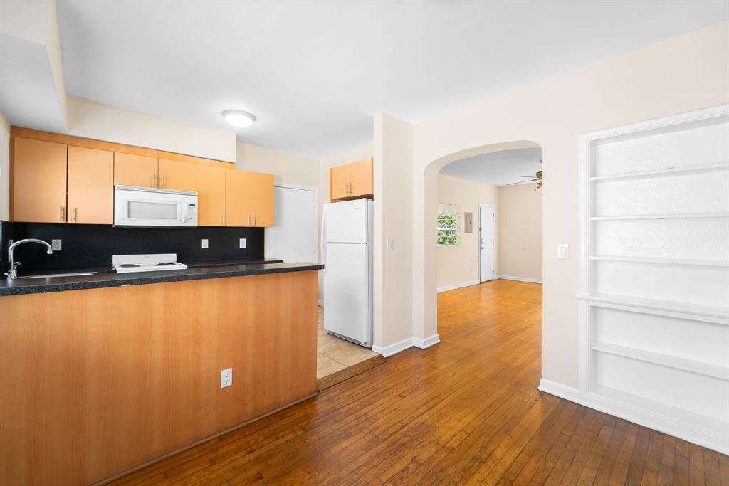 1241 13th Street, Unit 4 Miami Beach, FL 33139 - Photo 6 of 19 a view of a kitchen with wooden floor and a sink