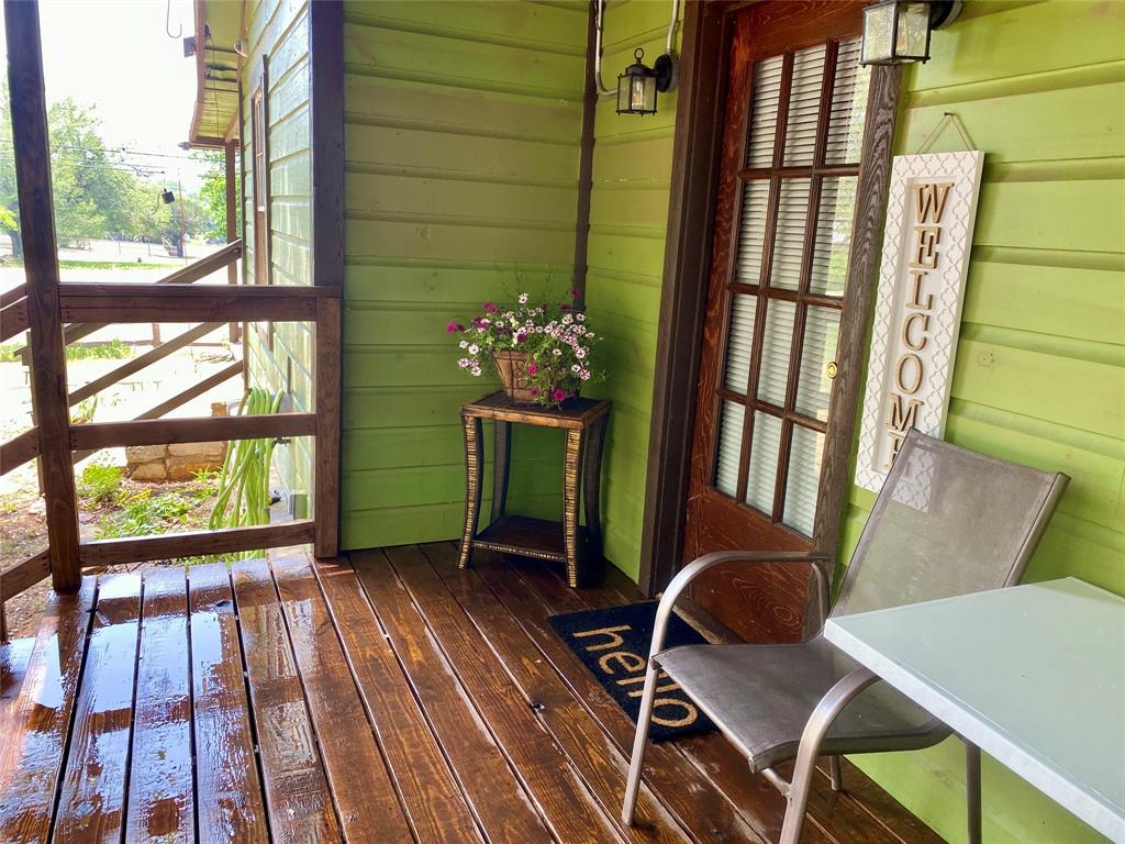 a view of a porch with furniture and a yard