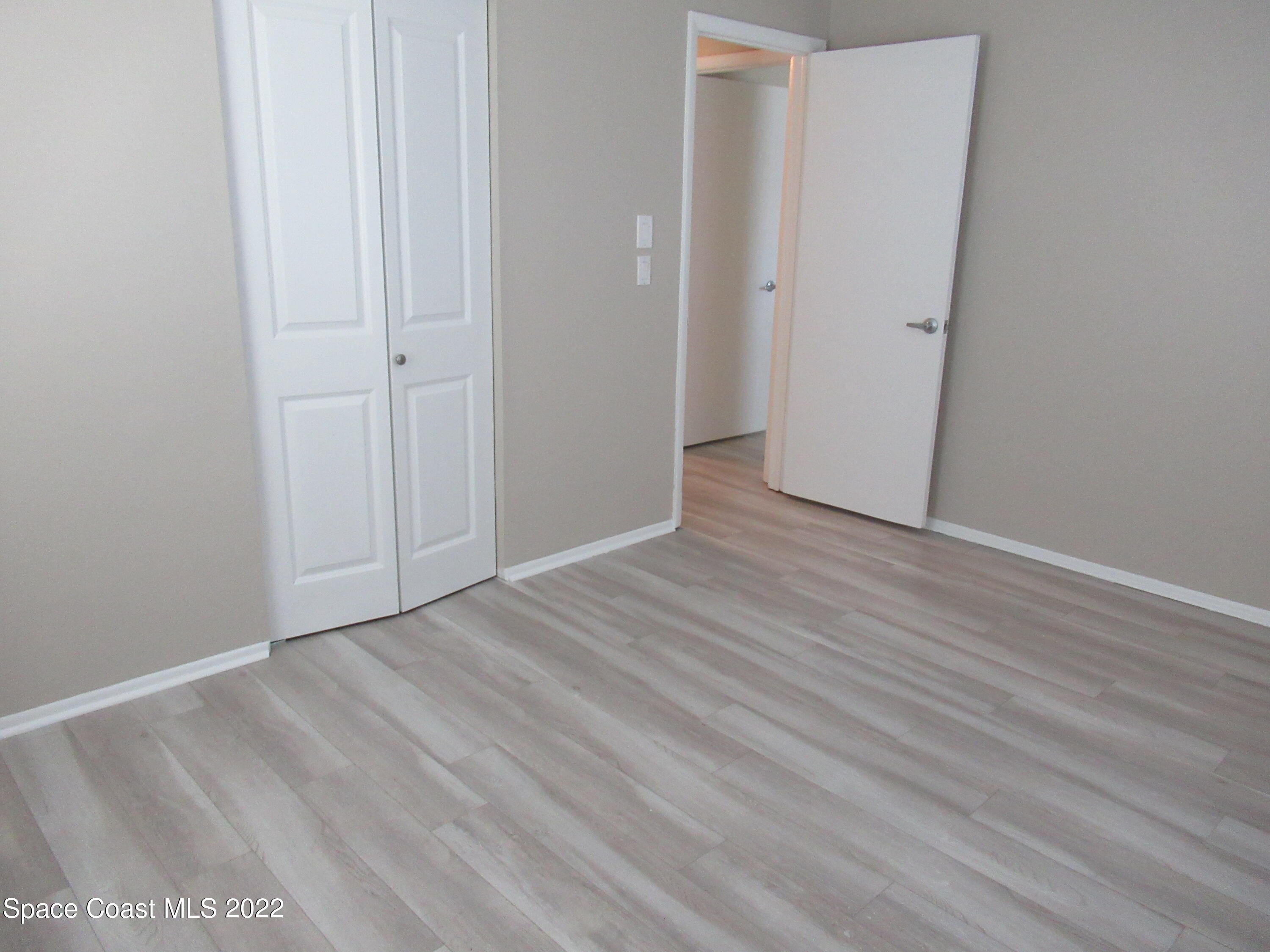 974 Bucknell Place Rockledge, FL 32955 - Photo 17 of 30 a view of an empty room with wooden floor