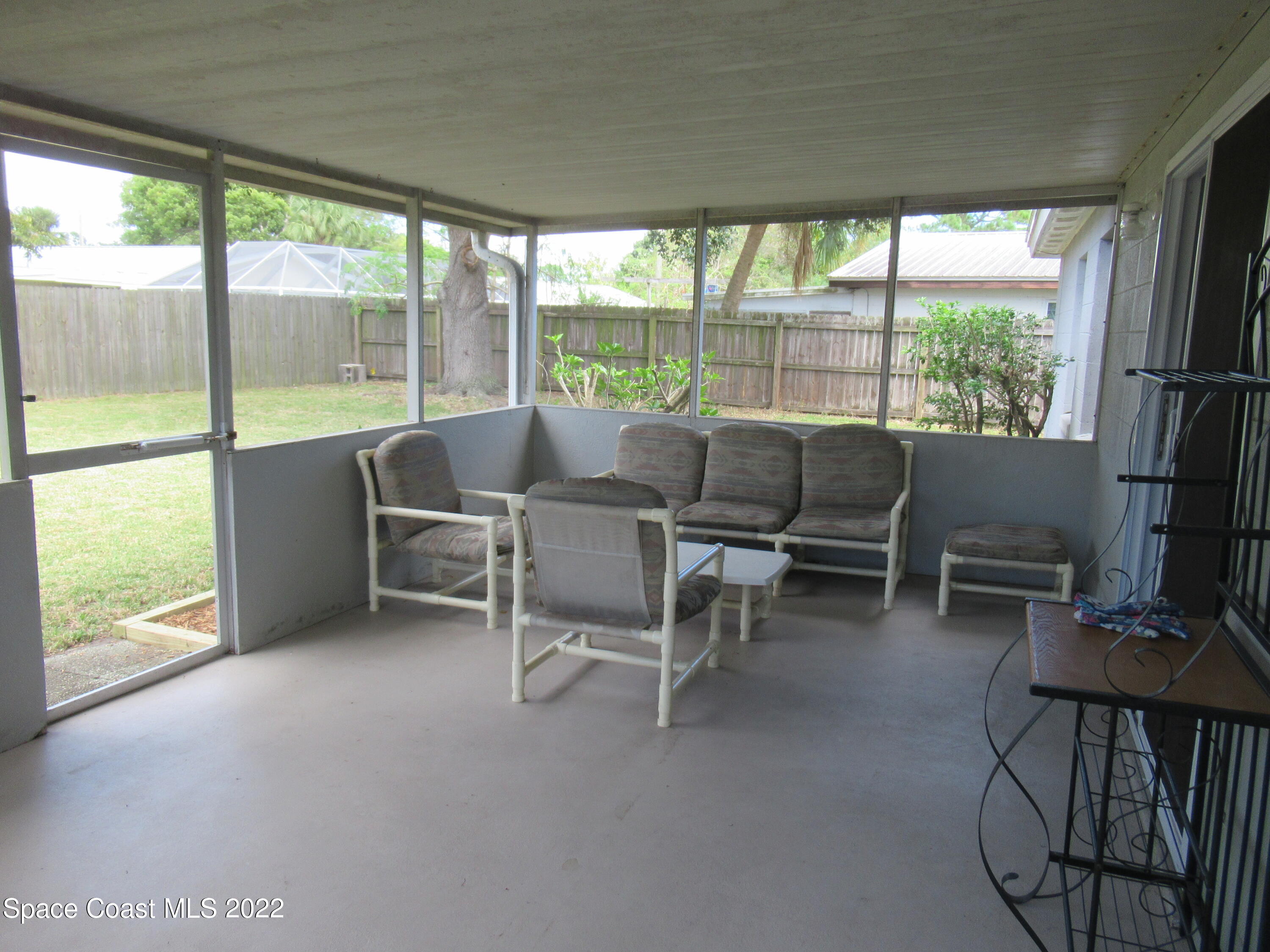 974 Bucknell Place Rockledge, FL 32955 - Photo 25 of 30 a living room with furniture and a floor to ceiling window