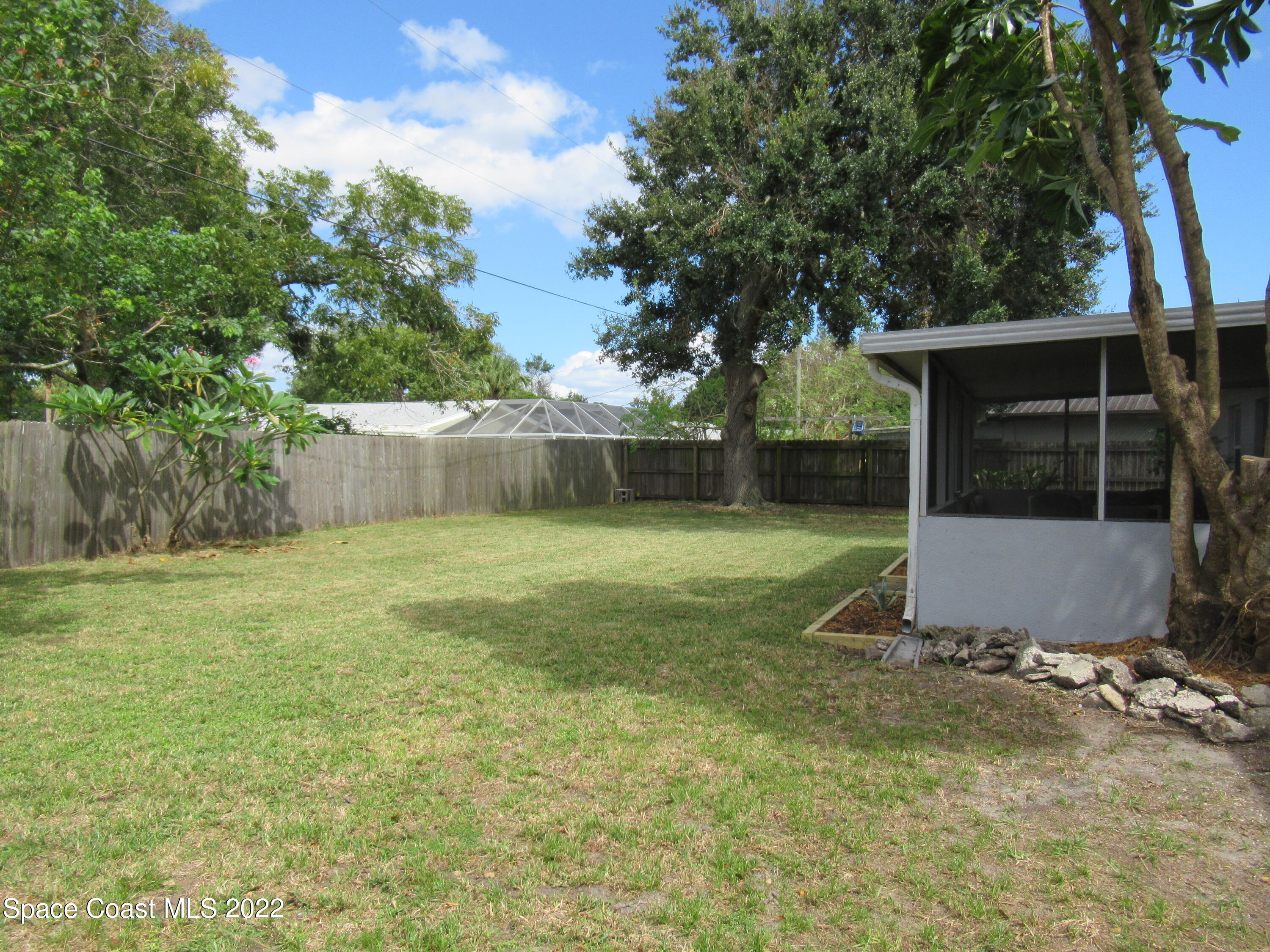 974 Bucknell Place Rockledge, FL 32955 - Photo 26 of 30 a view of a house with backyard and a tree