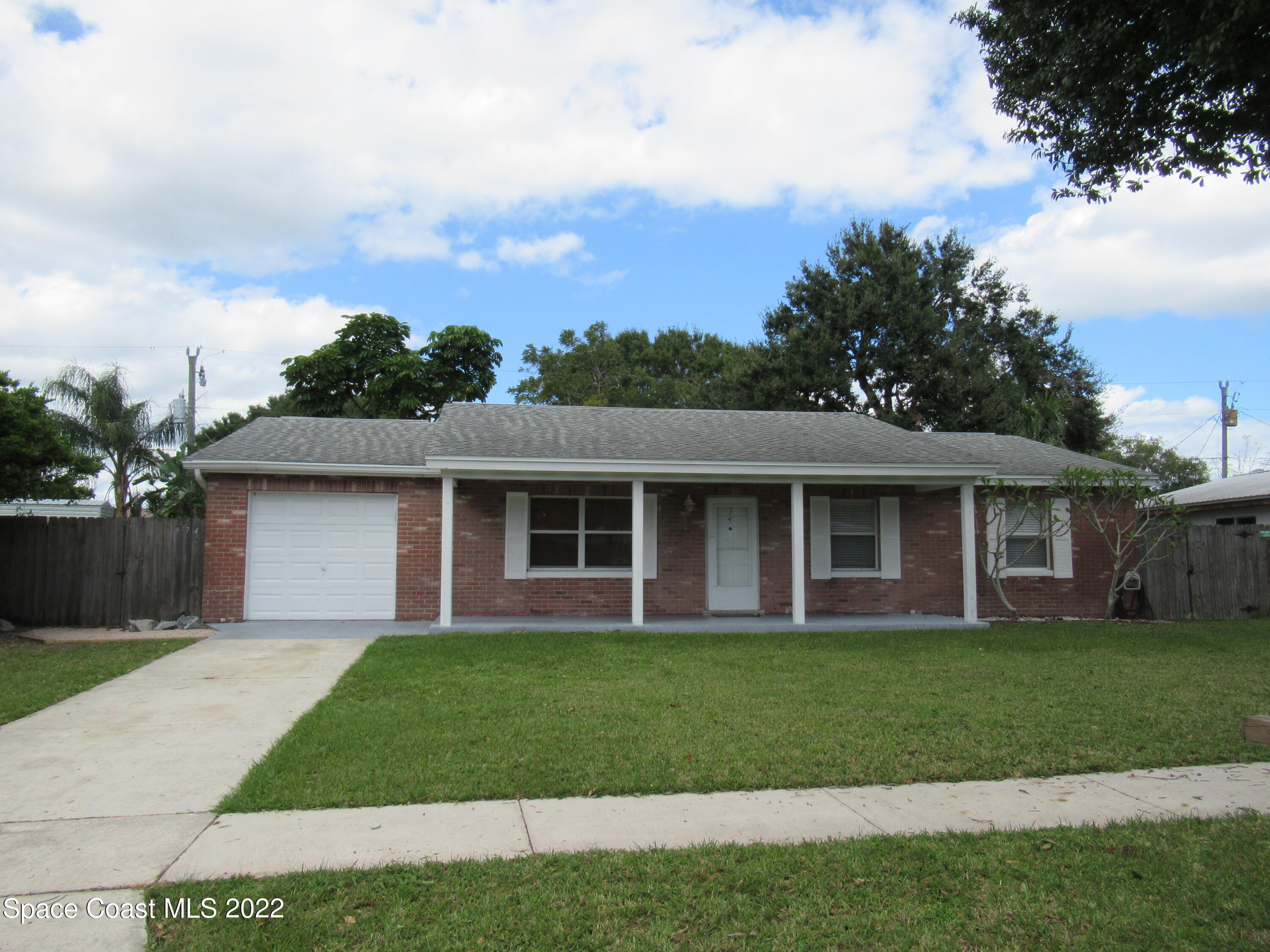 974 Bucknell Place Rockledge, FL 32955 - Photo 30 of 30 a front view of a house with a garden and yard
