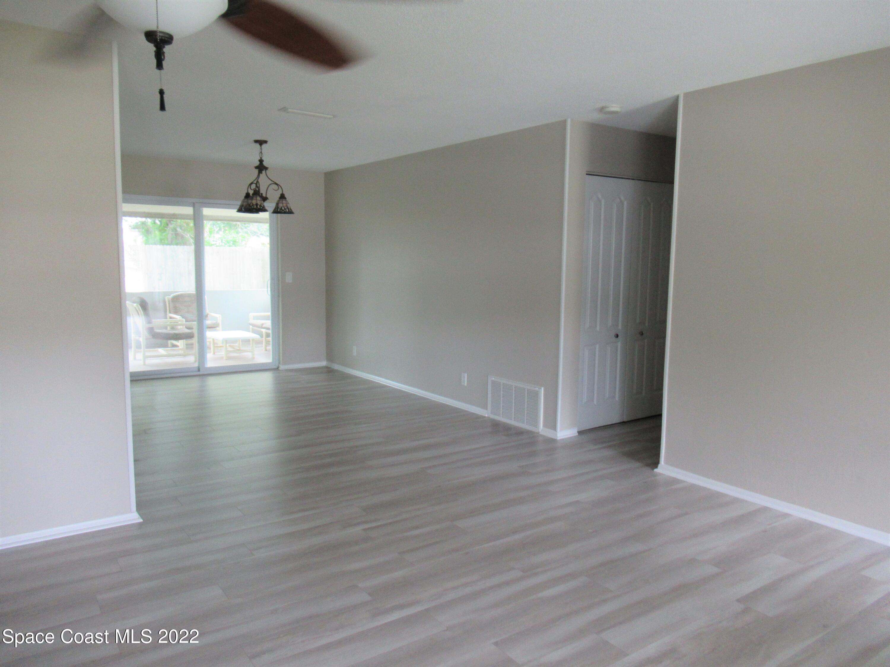 974 Bucknell Place Rockledge, FL 32955 - Photo 4 of 30 a view of an empty room with wooden floor and a window