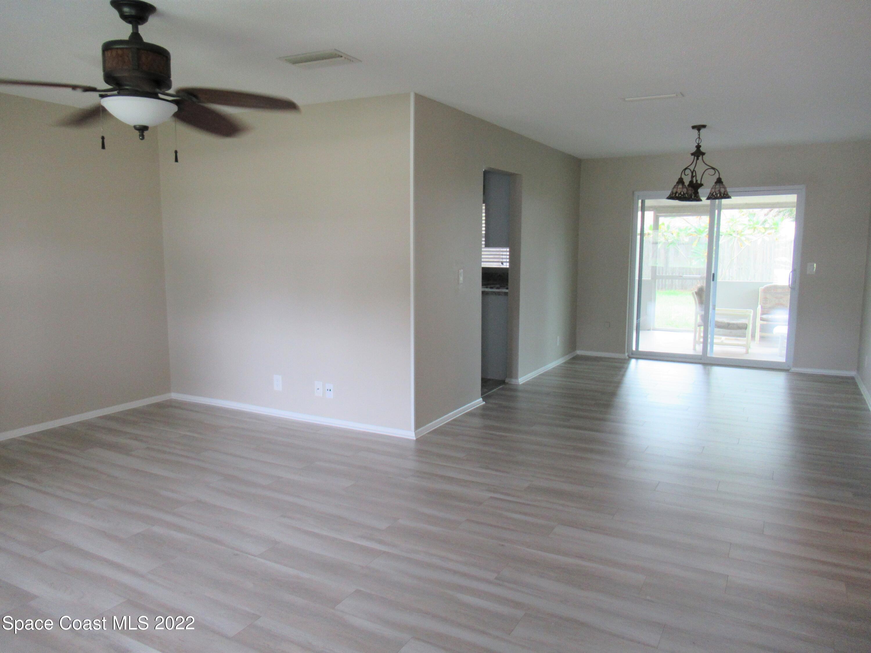 974 Bucknell Place Rockledge, FL 32955 - Photo 5 of 30 a view of an empty room with wooden floor and a window