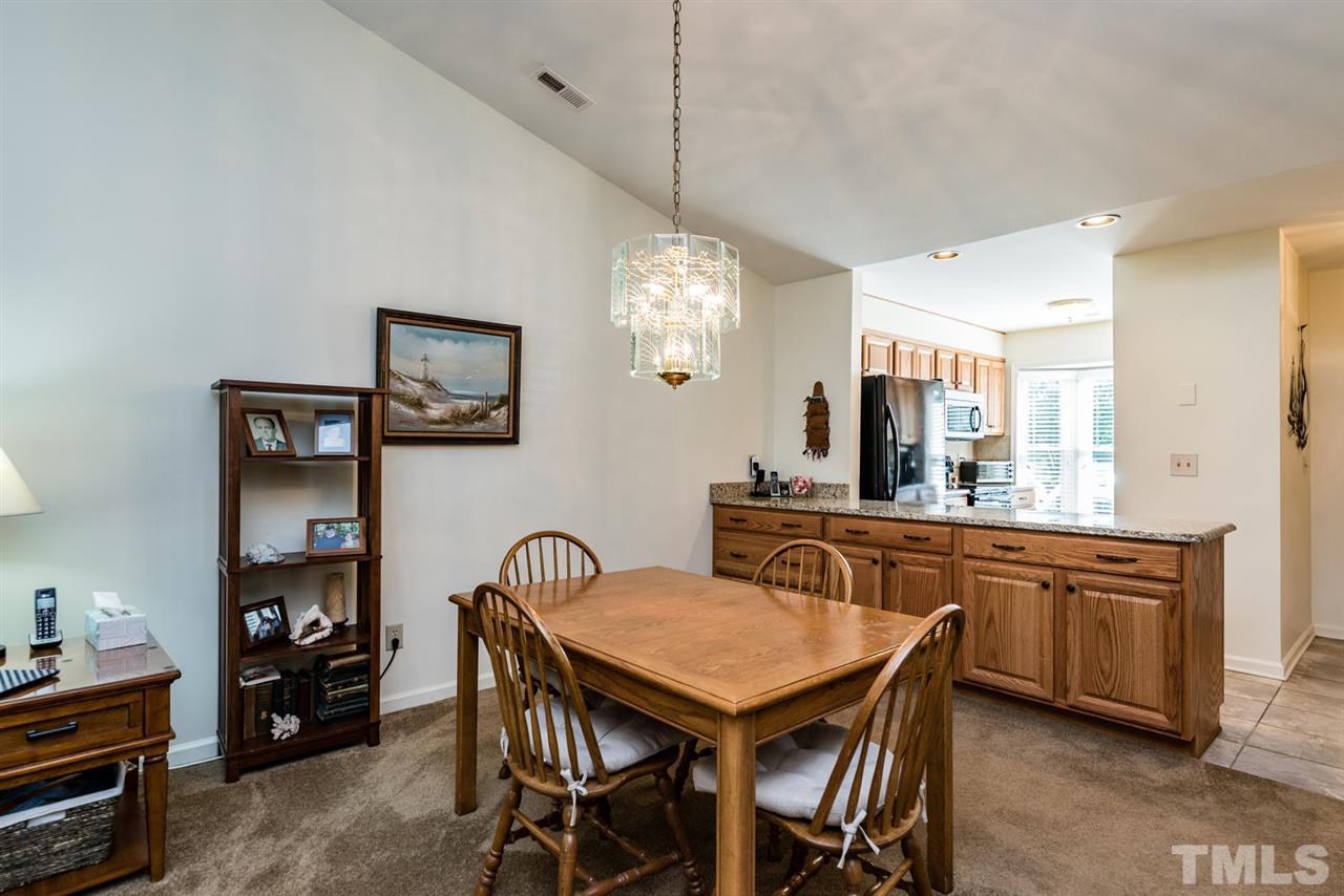 2603 Cottage Circle Raleigh, NC 27613 - Photo 13 of 25 a view of a dining room with furniture and chandelier