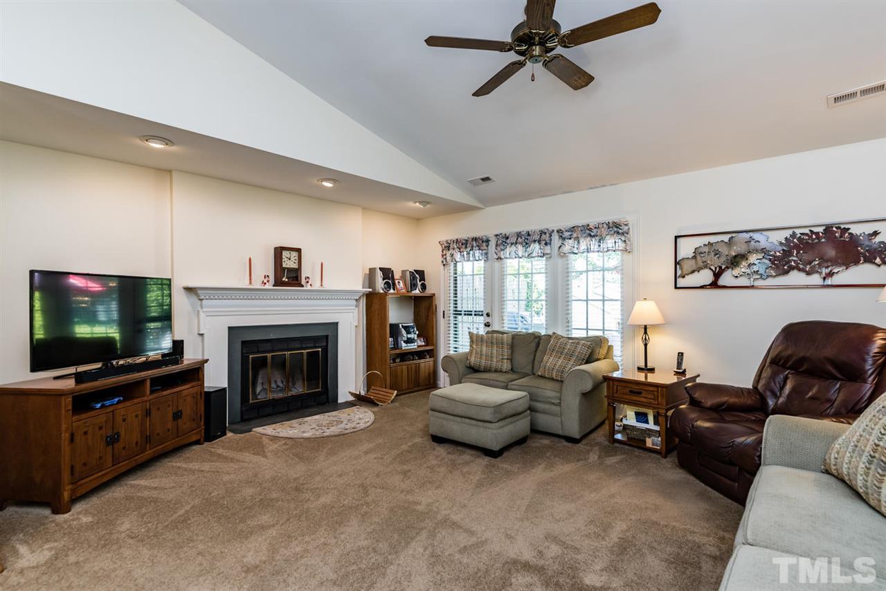 2603 Cottage Circle Raleigh, NC 27613 - Photo 15 of 25 a living room with furniture a flat screen tv and a fireplace
