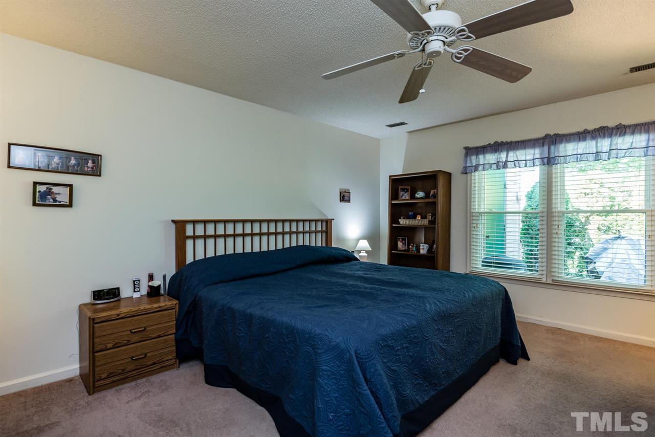 2603 Cottage Circle Raleigh, NC 27613 - Photo 17 of 25 a bedroom with a large bed and a large window